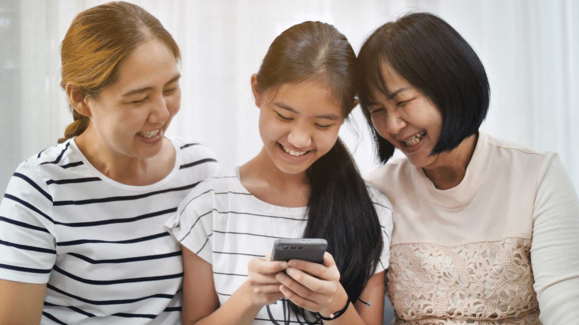 family playing heroes on phone