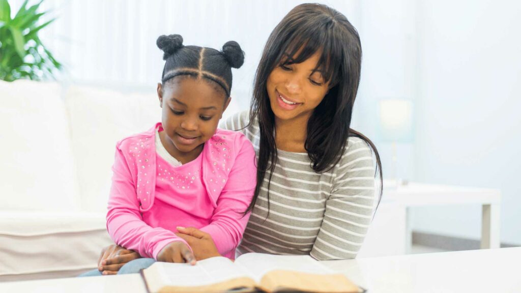 mother and child reading the bible