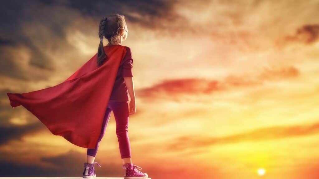 o que faz um herói? an image of a little girl wearing cape