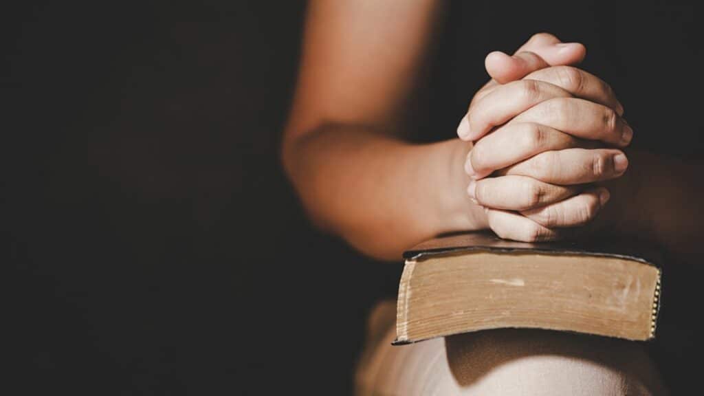 Who Were the “Heroes” Behind the Game Development of Heroes? 25 Heroes: Woman praying with a Bible